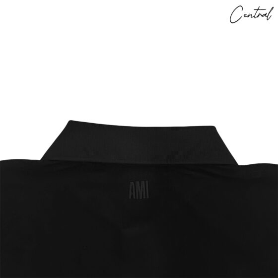 Ami Paris ADC embroidered polo shirt in navy blue with logo detail, featuring a classic collar and short sleeves.