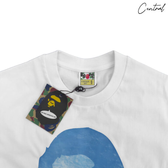 BAPE x Coca-Cola white tee featuring a graphic of the iconic Ape Head logo on the front.
