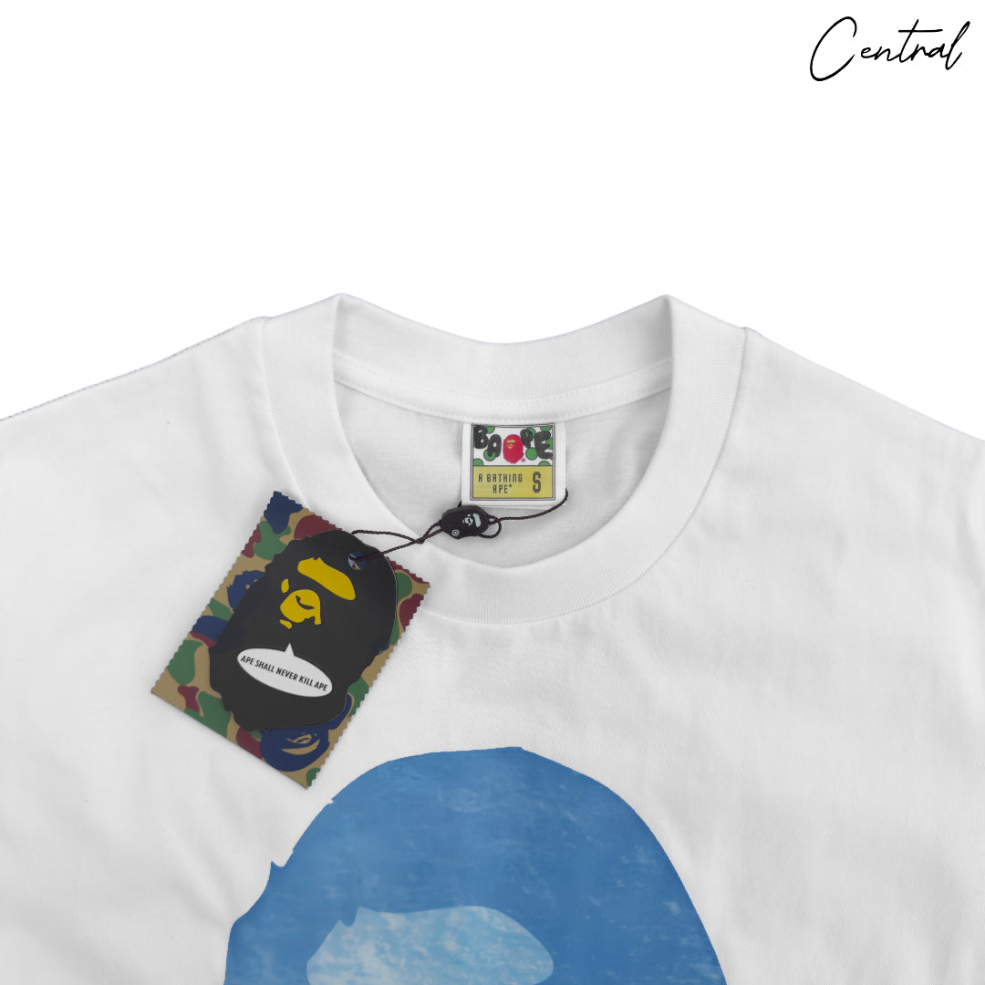BAPE x Coca-Cola white tee featuring a graphic of the iconic Ape Head logo on the front.