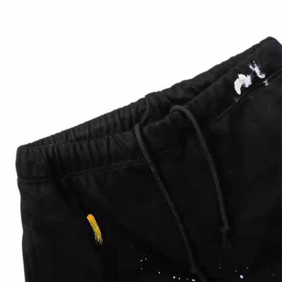 Central ae Gallery Dept paint splatter shorts with colorful splashes on a distressed denim fabric, displayed flat.