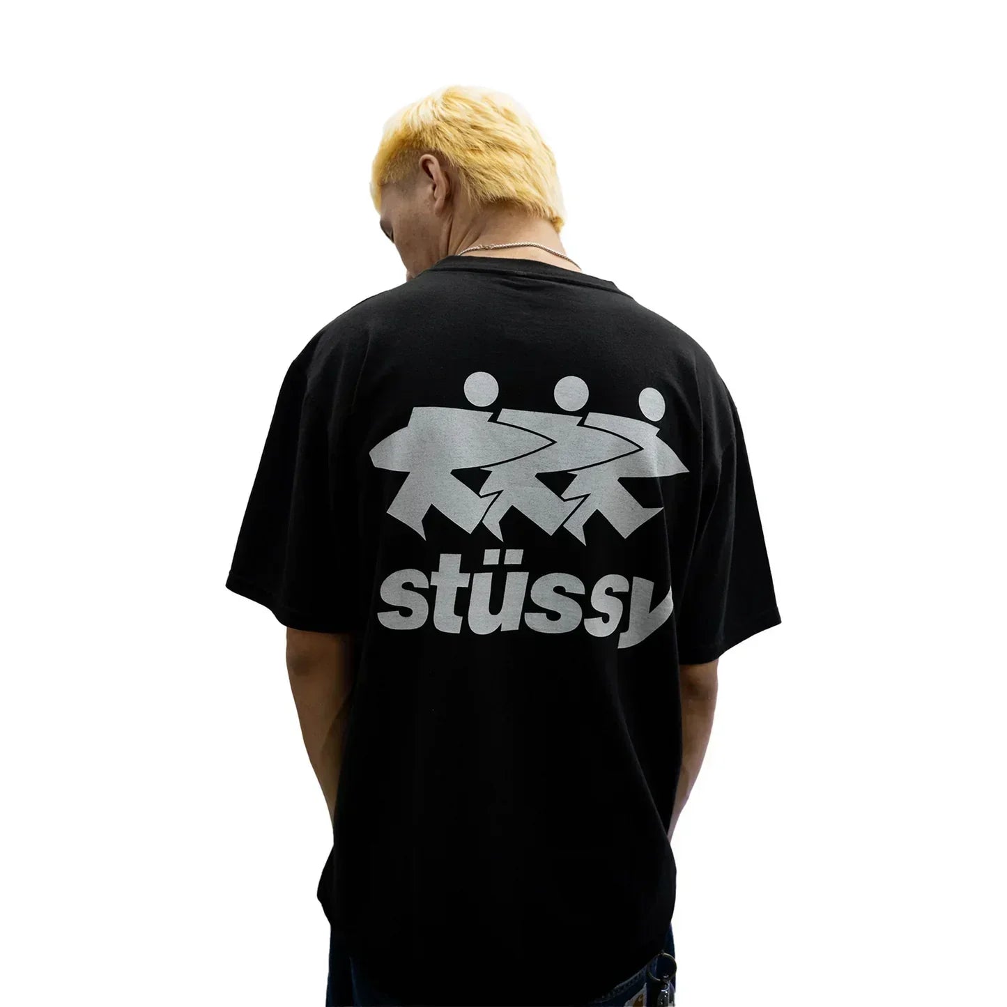 Model wearing a black Stussy SURFWALK t-shirt from Central ae, showcasing the back design and relaxed fit.