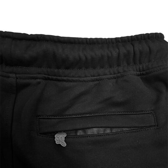 Black and rose gold Syna T-shirt and shorts set displayed flat, showcasing fabric texture and stylish design.