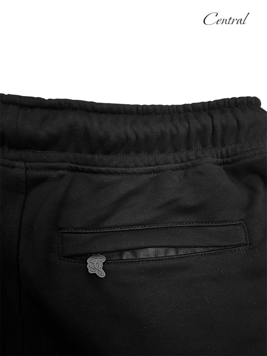 Black and rose gold Syna T-shirt and shorts set displayed flat, showcasing fabric texture and stylish design.