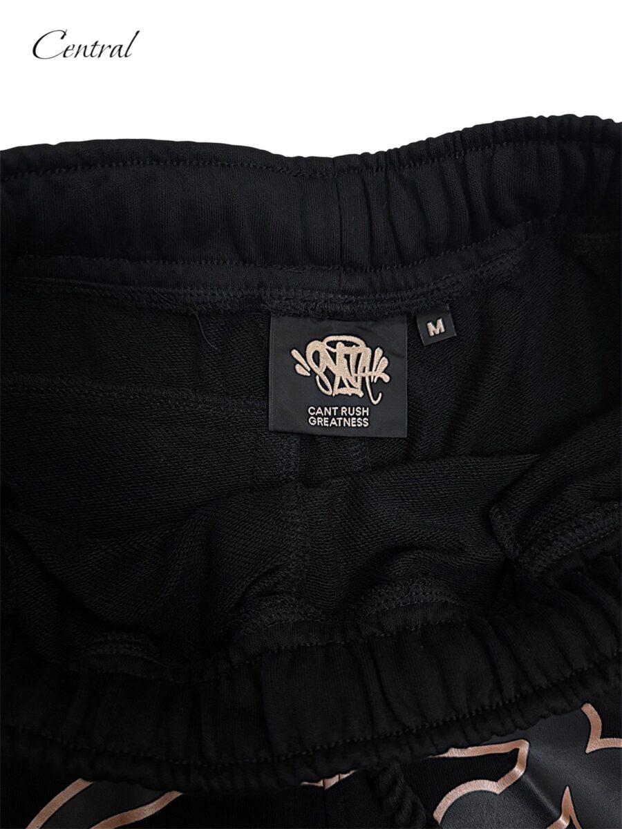 Black and rose gold Syna T-shirt and shorts set displayed on a flat surface. Casual style by Central.ae.