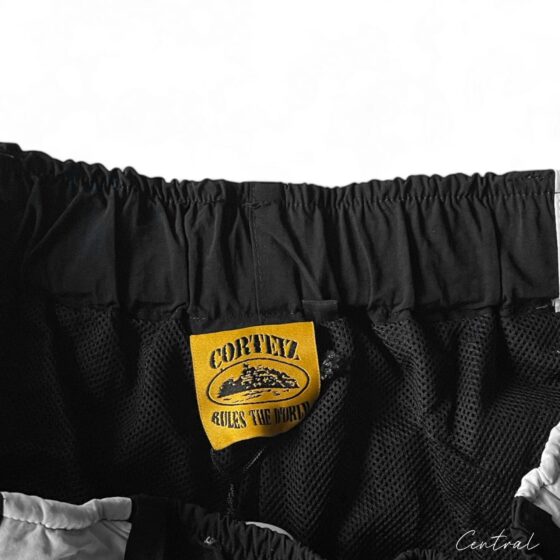 Corteiz black and white spring shorts from Central ae displayed on a flat surface, showcasing fabric and design details.