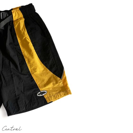 Black and yellow Corteiz spring shorts by Central ae, featuring a stylish design and comfortable fit.