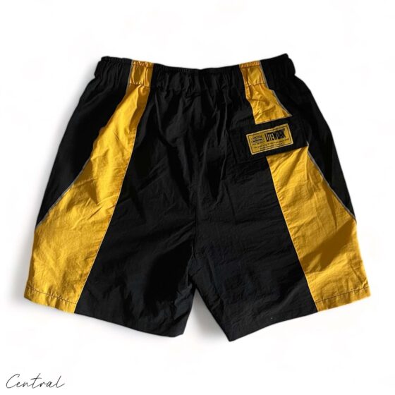 Black and yellow Corteiz Spring shorts by Central ae, featuring a stylish design and comfortable fit.
