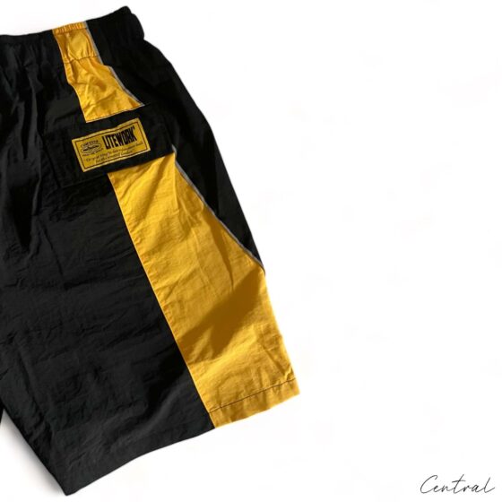 Corteiz black-yellow spring shorts by Central ae, featuring a relaxed fit and stylish design for casual wear.
