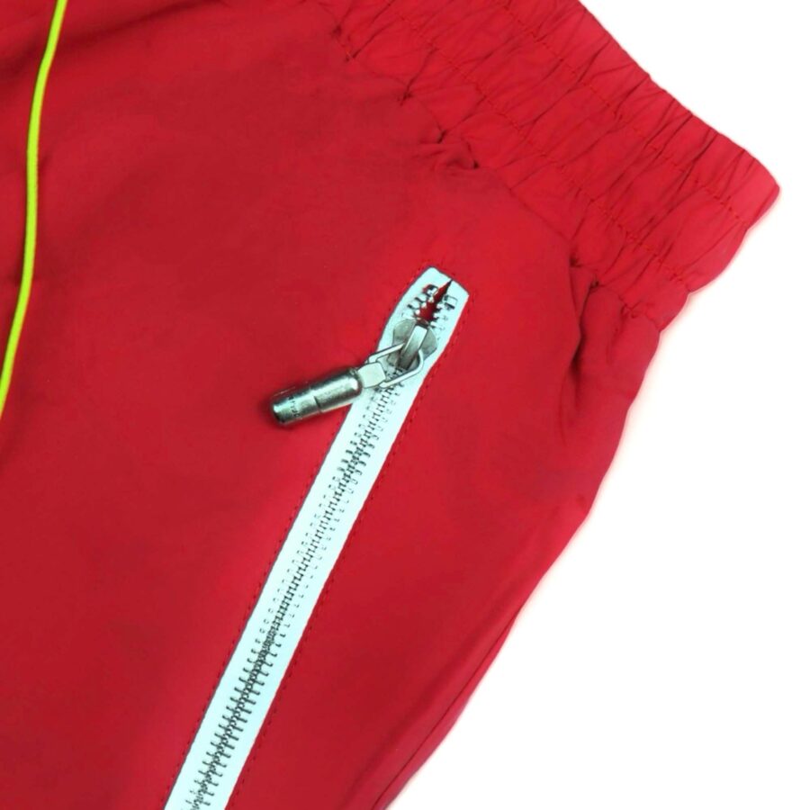 Red Rhude shorts displayed on a neutral background, showcasing a relaxed fit and contemporary design.