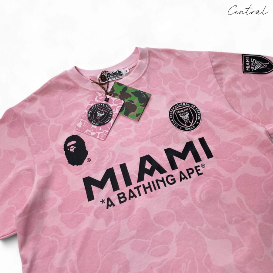 BAPE x Inter Miami pink camo t-shirt featuring a vibrant design and relaxed fit by Central ae.