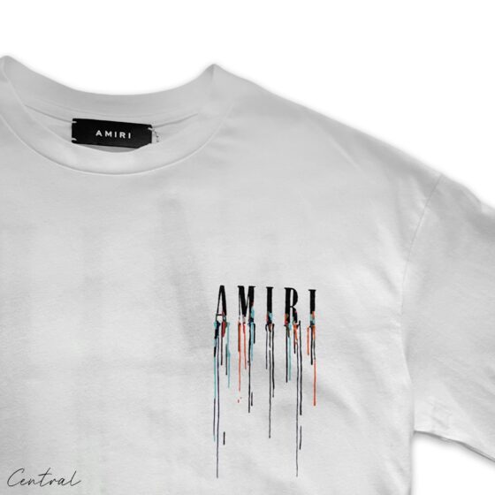 White Amiri Paint Drip T-Shirt by Central ae featuring unique paint drip design on a classic crew neck style.