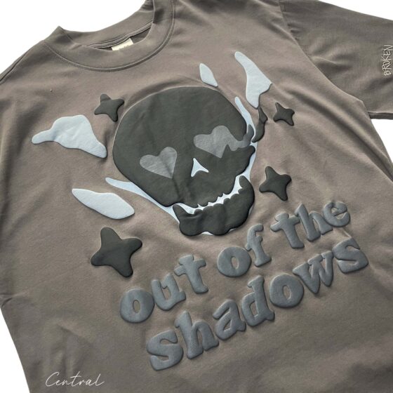Central ae Out of the Shadows T-shirt featuring a unique graphic design and a comfortable fit on a casual background.