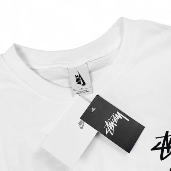 White NIKE X STUSSY 8 Ball T-shirt featuring logo graphics on the front and back, casual fit for everyday wear.
