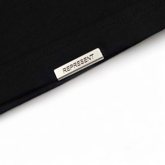 Black Represent 'Your Tute’s Up' t-shirt displayed on a neutral background, showcasing the front design and fabric texture.