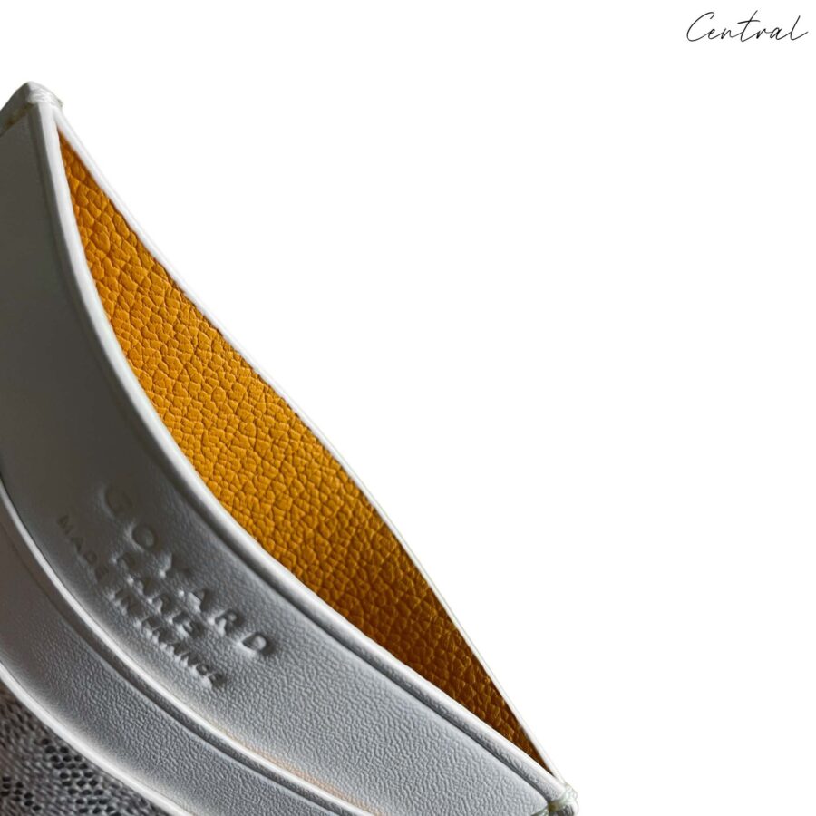 White Goyard card holder wallet from Central ae featuring signature logo pattern and sleek design.