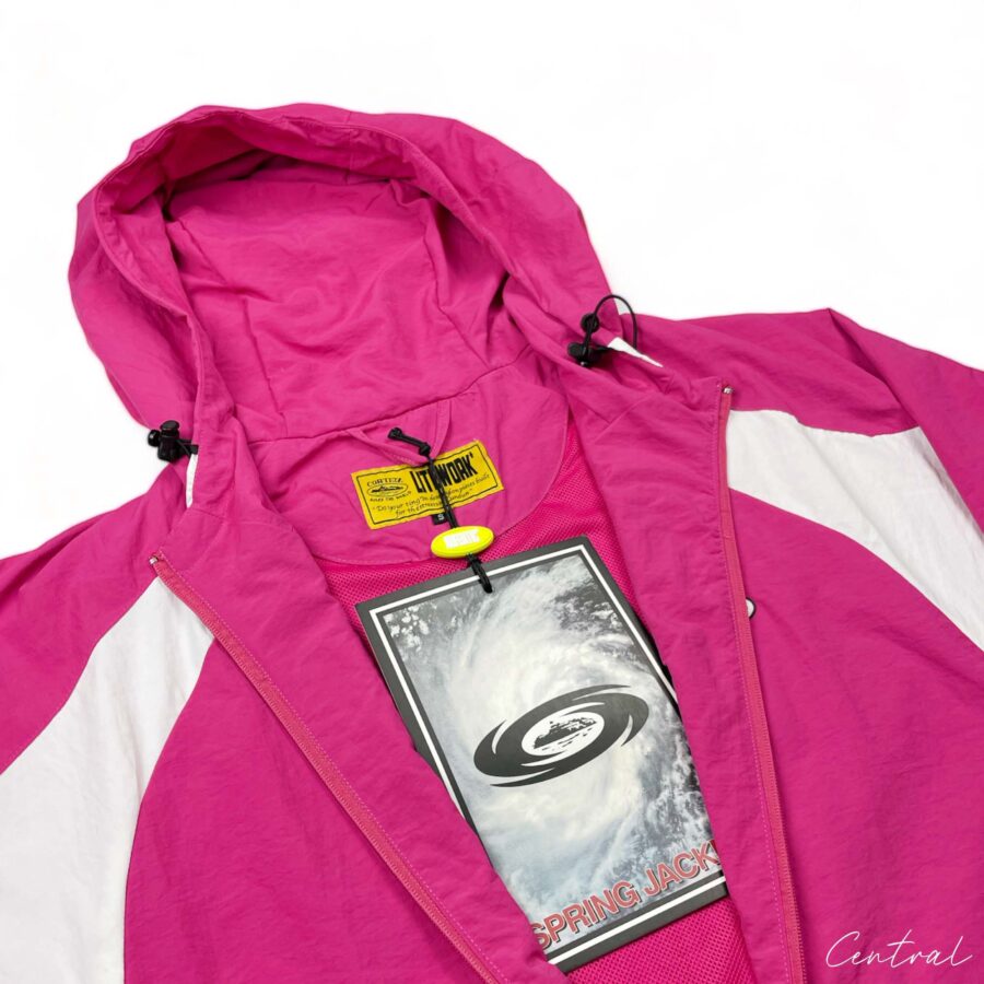 Corteiz pink spring hoodie displayed on a hanger, featuring a zip-up front and casual style for comfortable wear.