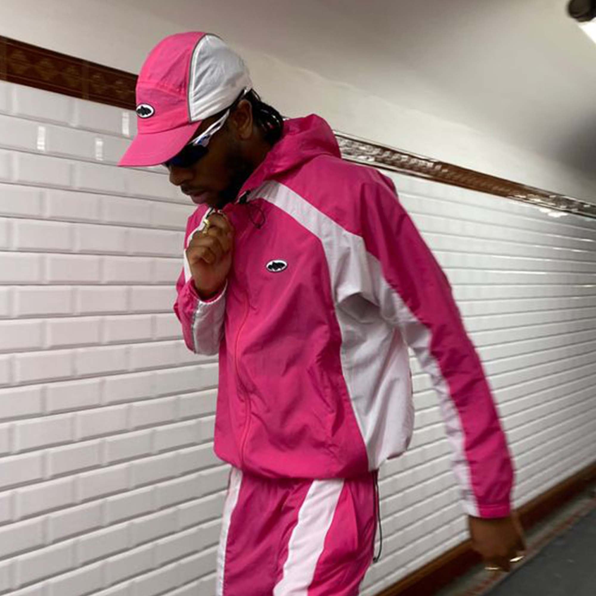 Corteiz pink spring hoodie with a relaxed fit and adjustable drawstring hood displayed against a neutral background.