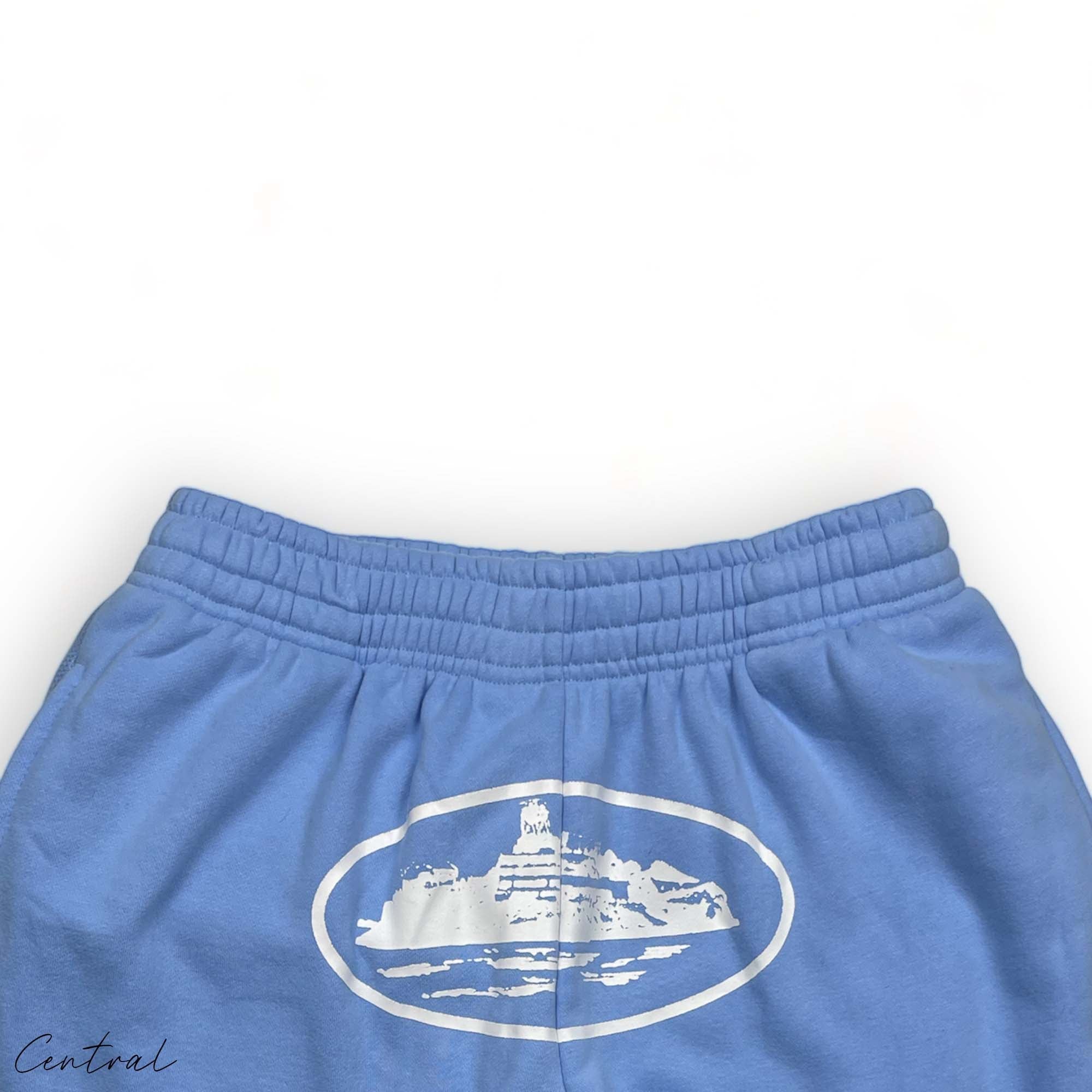 Baby blue Corteiz Alcatraz sweatpants featuring a relaxed fit and central logo on the left thigh.