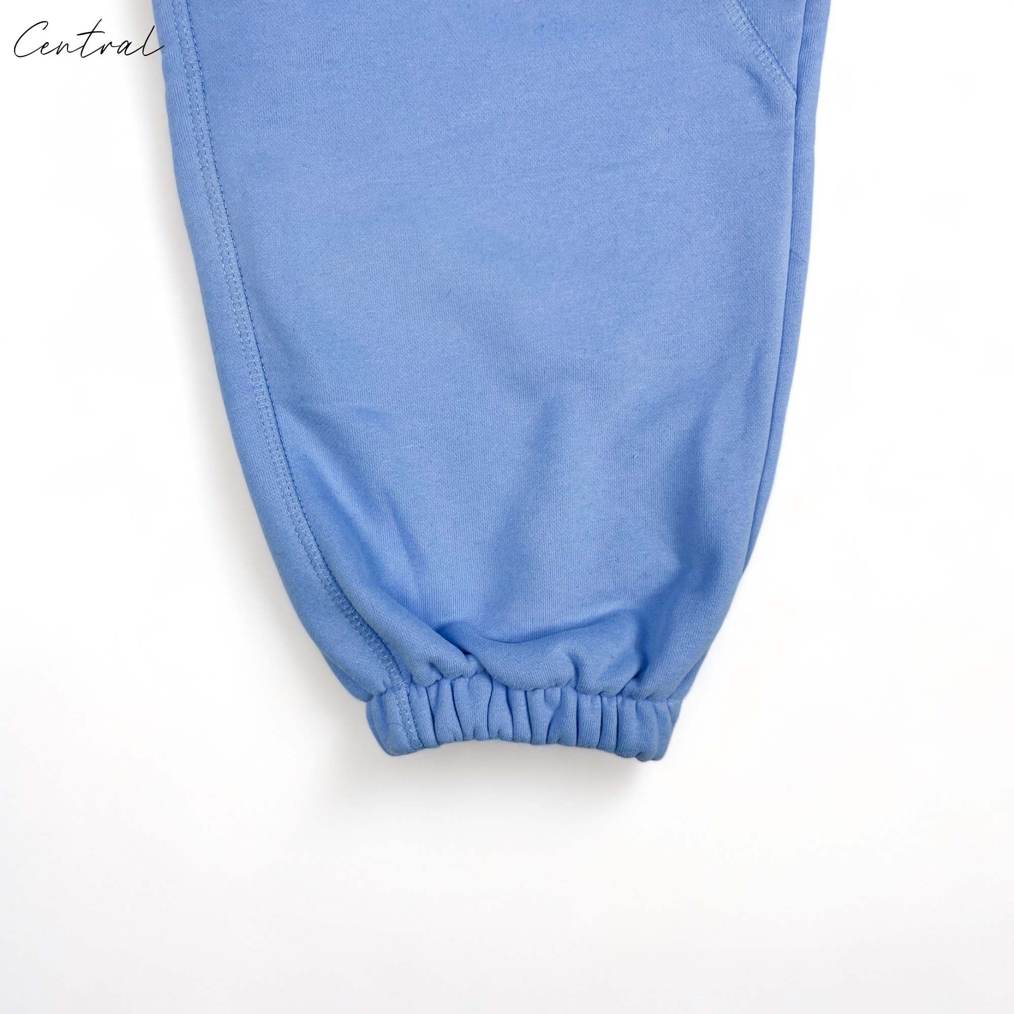 Corteiz Alcatraz sweatpants in baby blue, featuring a relaxed fit and elastic waistband, displayed on a neutral background.