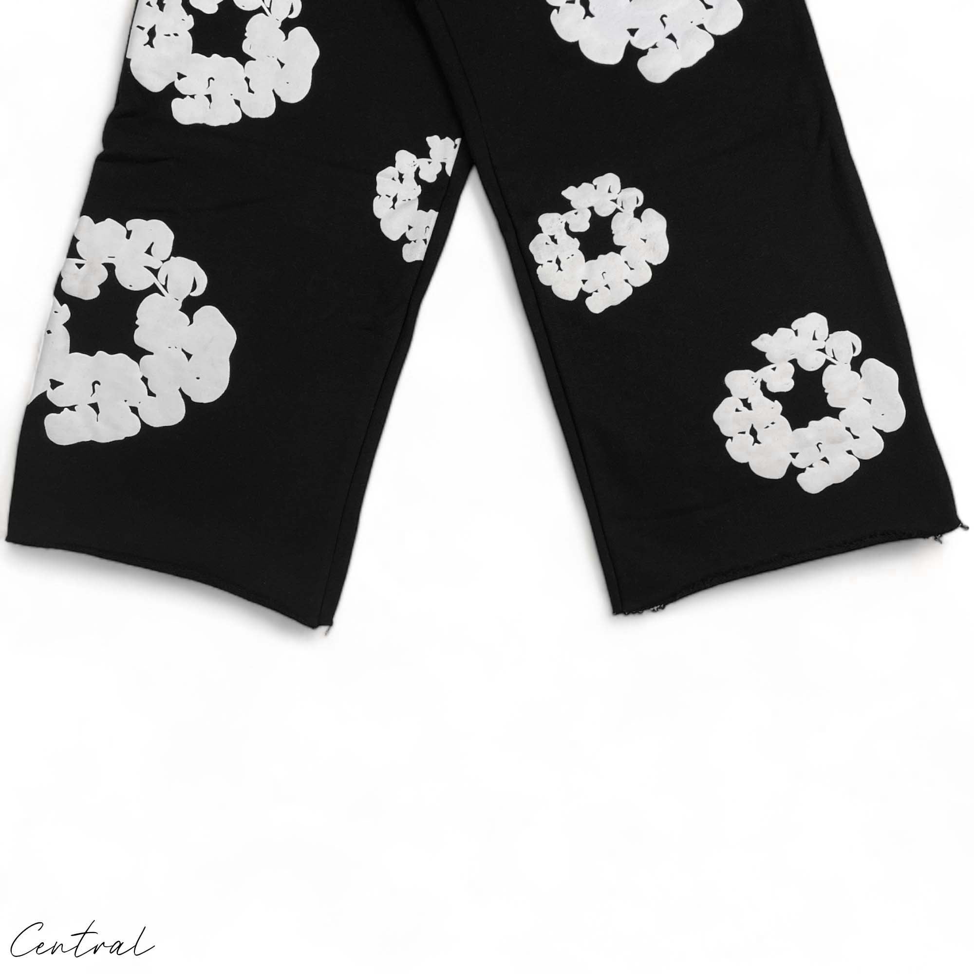 Black READYMADE x DENIM TEARS sweatpants with a relaxed fit and unique detailing, showcased on a flat surface.