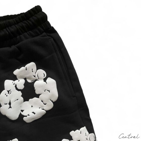 Black Denim Tears Cotton Wreath Shorts displayed on a neutral background, showcasing unique design and texture.