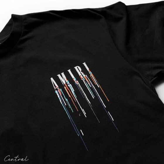 Amiri black t-shirt featuring a paint drip design, showcasing a stylish and modern casual look.