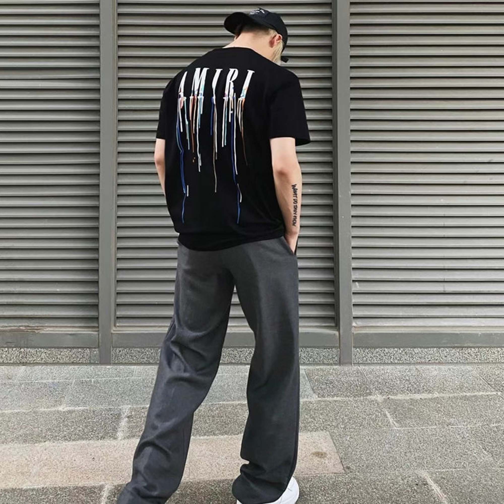 Amiri Paint Drip Black T-Shirt featuring a unique paint drip design on a classic black tee.
